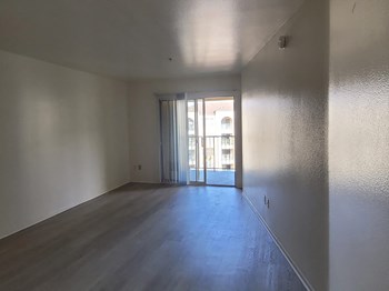 Vacant living room with hardwood style floors at Harvard Yard and Glenmary Apartments in Los Angeles CA